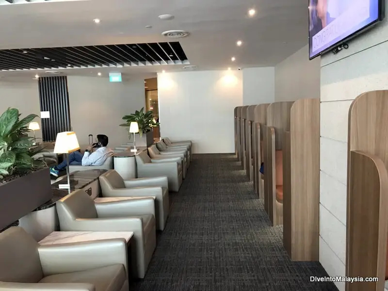 At the edge of the room by the productivity pods SATS Premier Lounge