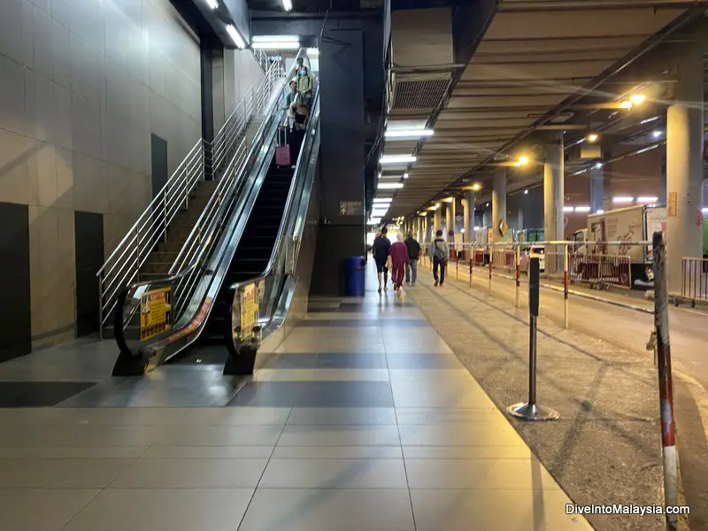 After you get down these escalators, turn around and walk behind them for Genting bus