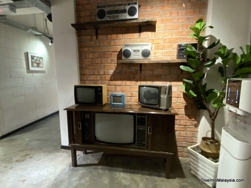 Muo Boutique Hotel entry way with old tvs and water